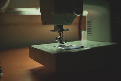 black sewing machine on white table